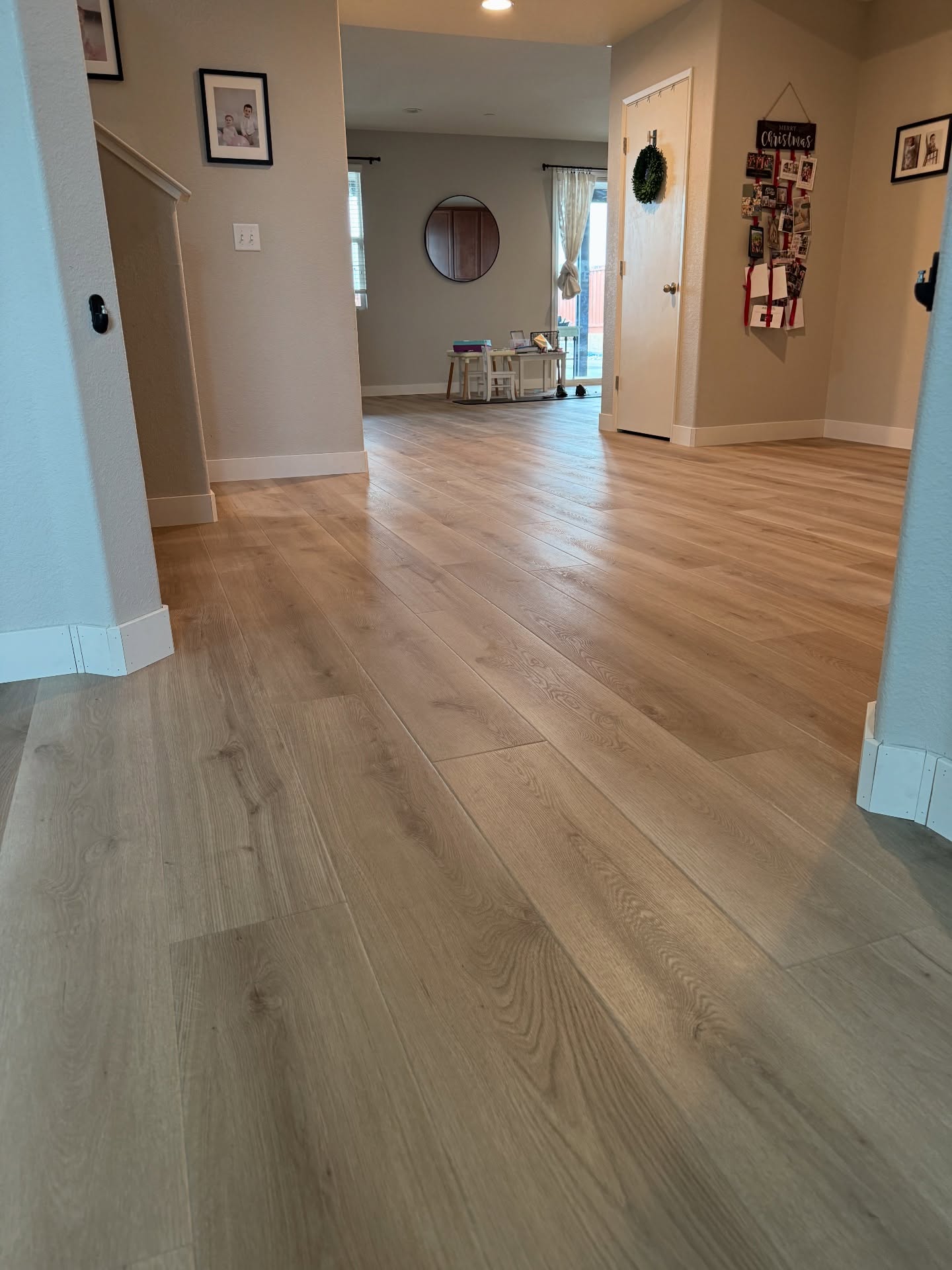 Wide plank oak flooring through open concept hallway and main floor