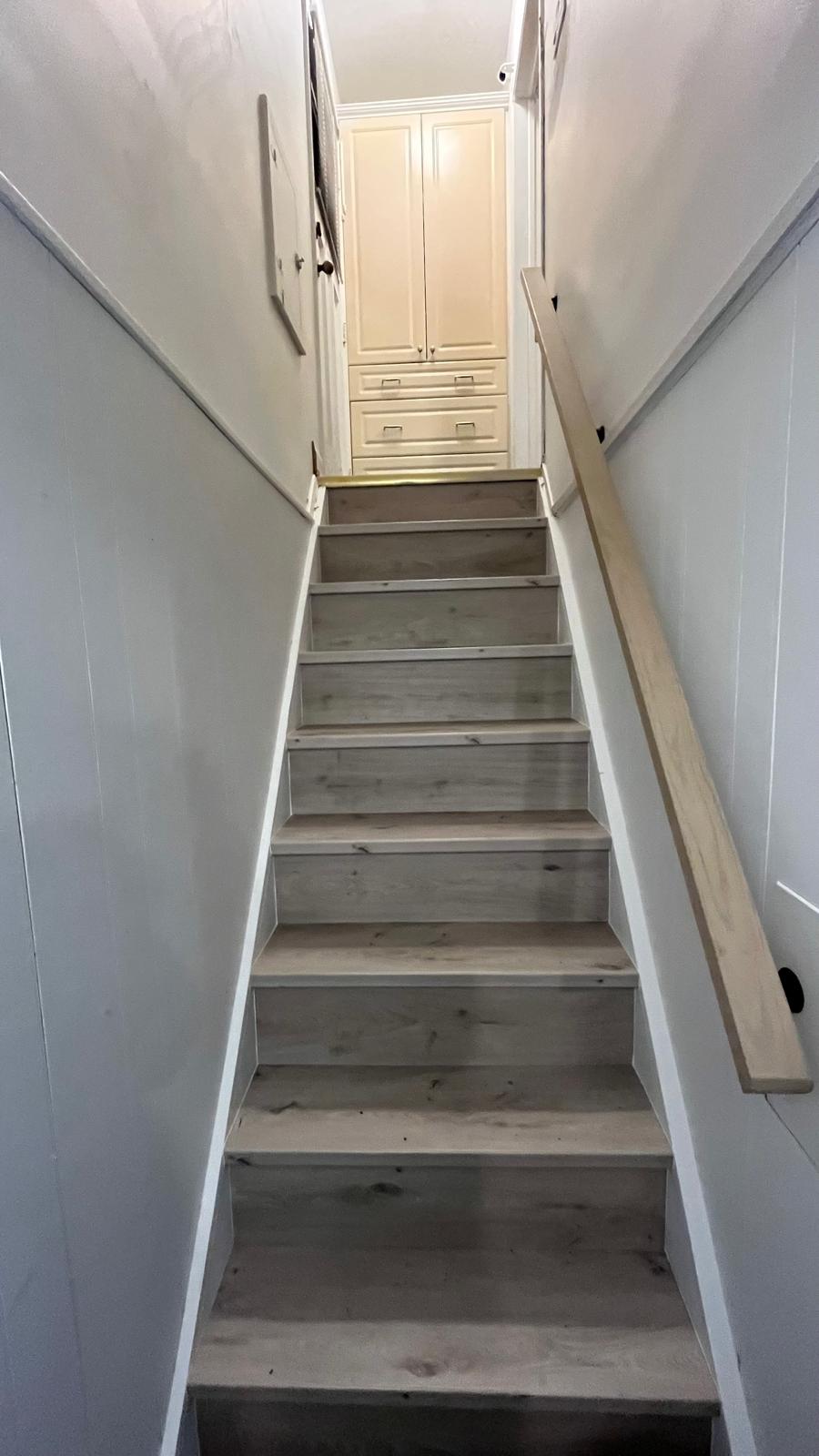Light grey oak vinyl plank covered staircase